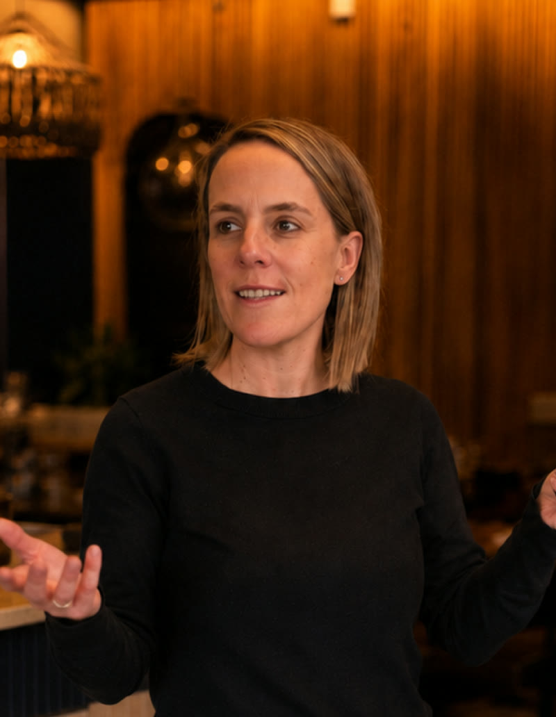 Jessica Pallister presenting inside an Ocean Basket restaurant